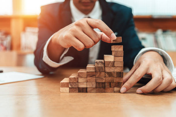 istock Ant eye view Male hand stacking wooden blocks. Business development and growth concept 1227147659