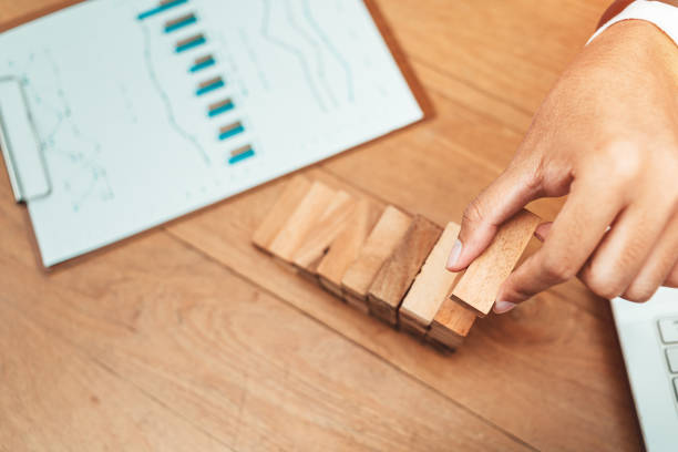 istock Male hand stacking wooden blocks. Business development and growth concept 1227147700