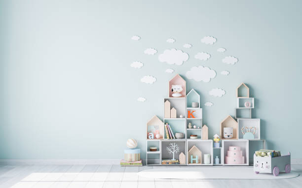 Fashionable Scandinavian kids playroom with bookshelf and wooden toys on pastel green wall with cloud on it stock photo