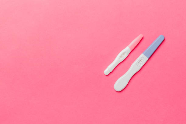 istock Colored Pregnancy test on colored background, top view with copy space 1227150779