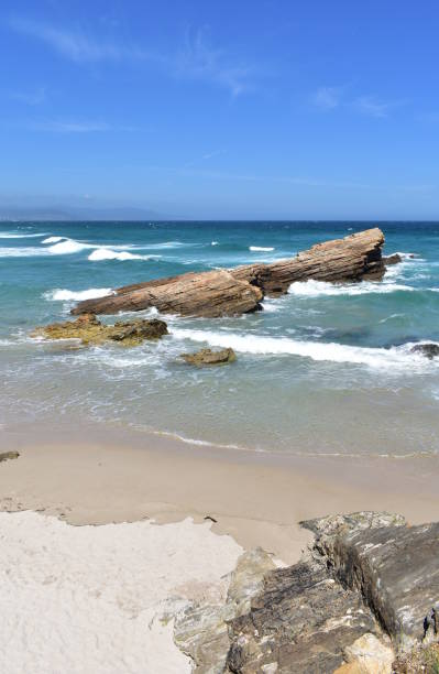 istock Beach with rocks, turquoise sea, waves and blue sky. Viveiro, Spain. 1227150895