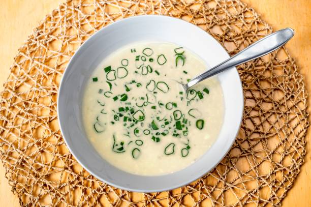 istock Cheese soup with green onion circles in plate, closeup. 1227153203