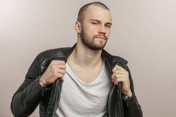 istock young trendy man in leather black jacket posing to the camera 1227154041