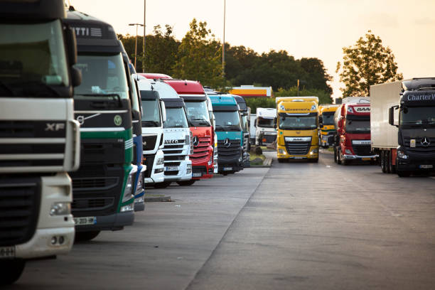 Medenbach, Germany - May 25, 2020: Parked trucks on German rest area Medenbach at highway A3 in Germany at dusk. Many rest areas are completely overloaded during evening hours due to the high truck traffic density in Germany