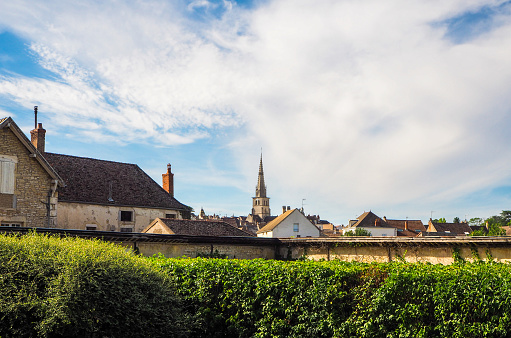 Golden stone bell tower of the Saint-Etienne Church in the village of Jarnioux, in Beaujolais