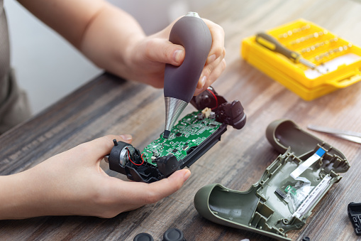 Toronto, Canada - May, 23,2020: Close up of disassemble game controller repairing, cleaning or diagnostic.