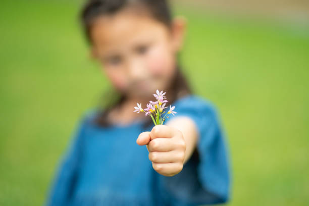 istock Child holding a small flowers 1227157605