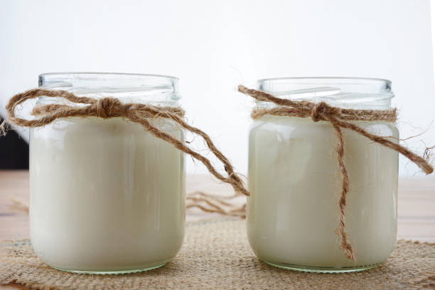 istock Natural yogurt, walnuts and cinnamon on wooden background 1227158822