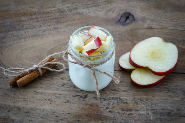 istock Natural yogurt, walnuts and cinnamon on wooden background 1227159121