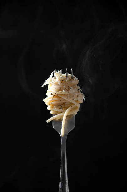 istock Spaghetti on Fork with Steam on Dark Background. Cacio e Pepe - Italian Pasta with Cheese and Pepper 1227159272