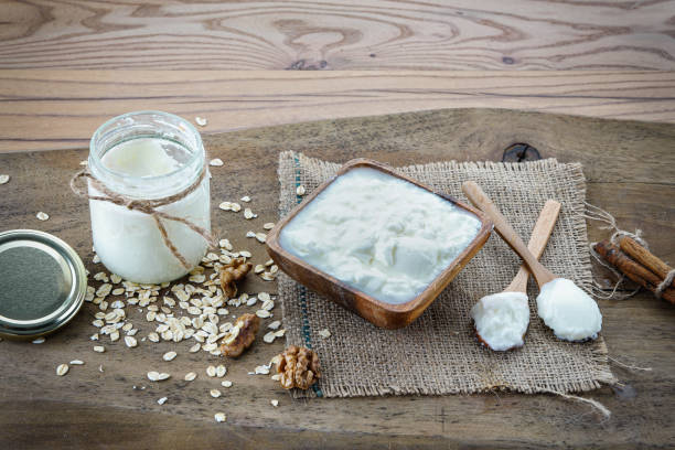 istock Natural yogurt, walnuts and cinnamon on wooden background 1227159459
