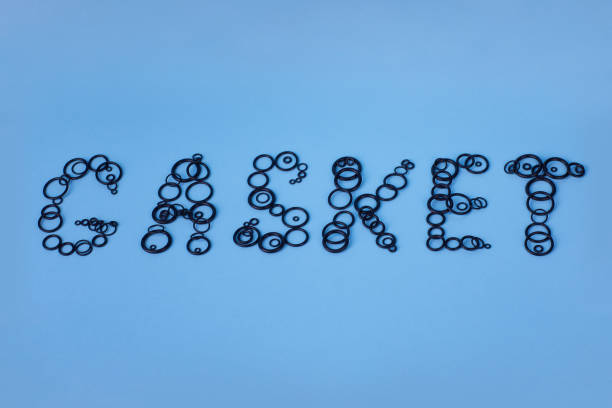 Word "Gasket" made of black rubber o-ring seals. Rubber rings. Word "Gasket" made of black rubber o-ring seals. Rubber rings. Sealing gaskets for hydraulic joints. Rubber sealing rings for plumbing. Top view rubber seals for pipes stock pictures, royalty-free photos & images