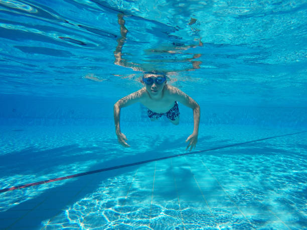 istock Child boy swimming pool water playing summer vacation fun 1227160190