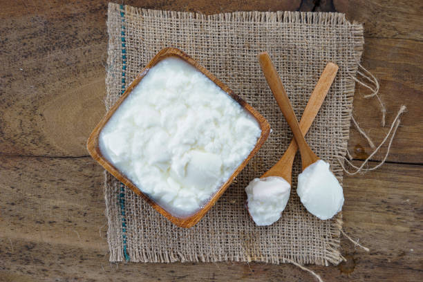 istock Natural yogurt, walnuts and cinnamon on wooden background 1227162028