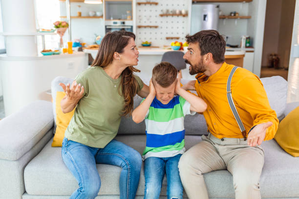 Upset son suffering from parents arguing Frustrated little school boy feeling depressed while angry parents fighting at home. Worried upset small son hurt by fathers and mothers break up or divorce, children and family conflict concept. arguing couple divorce family stock pictures, royalty-free photos & images