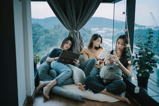3 asian chinese beautiful women spending weekend together at home apartment bonding
