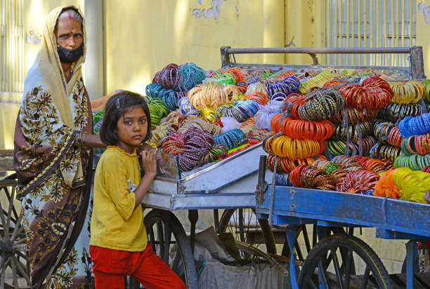 COVID-19 Lockdown : Bangle Market in Rajasthan Beawar, Rajasthan, India - May 21, 2020: A bangle seller wait for customers at city market amid ongoing COVID-19 nationwide lockdown baby bracelet stock pictures, royalty-free photos & images