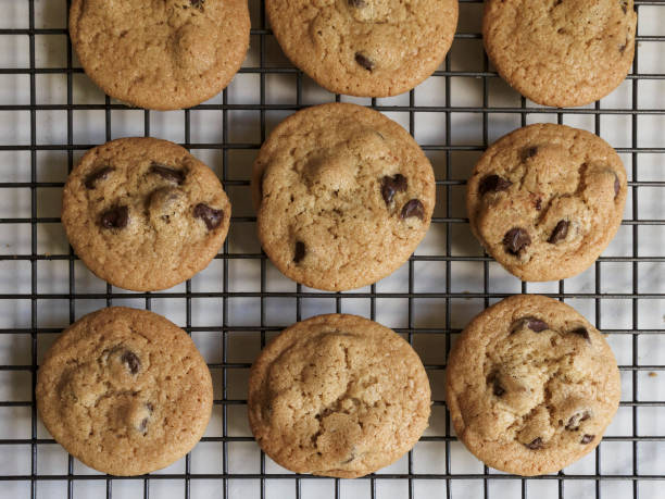 Homemade chocolate chip cookies tied white ribbon with milk on wooden table