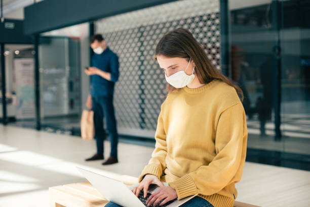 istock female blogger in a protective mask works on a laptop 1227167597