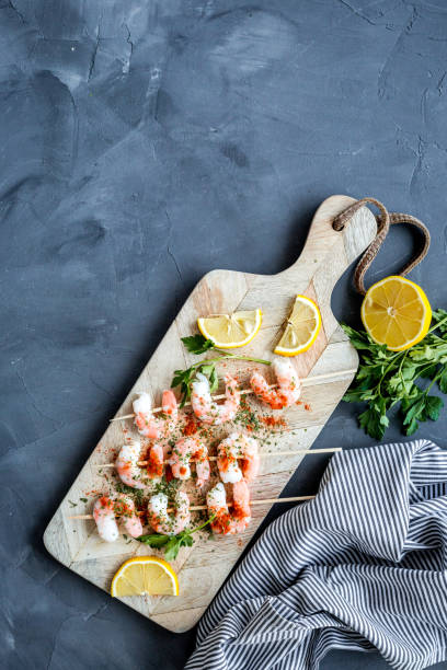 istock Shrimp skewers - seafood - on grey table top view copy space 1227167604