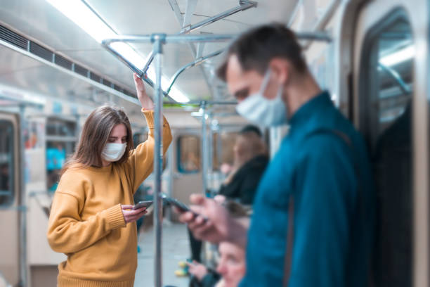 istock young woman in a protective mask standing in a subway car 1227167665