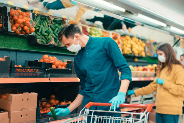 istock shoppers in protective masks choosing fruit in the supermarket 1227167671