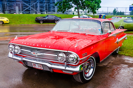 Moncton, New Brunswick, Canada - July 10, 2016 : 1960 Chevrolet Impala wet from the rain at 2016 Atlantic Nationals Automotive Extravaganza in Centennial Park, Moncton, New Brunswick, Canada.