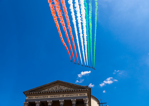 Turin, Piedmont, Italy - May 25, 2020: View of the Frecce Tricolori that speed on the Gran Madre di Dio Church, in the city center.