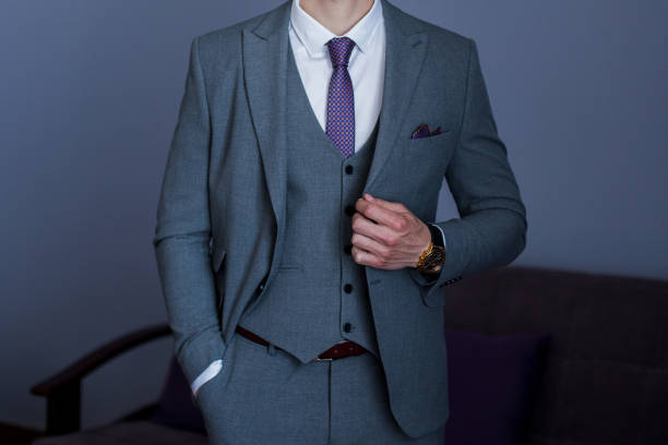 istock man puts on a suit in the room 1227171365