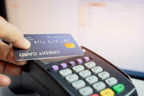 istock Customer using credit cards (mock up) for payment to owner at counter store,  making pay through nfc technology, paying with contactless card for business service trade concept 1227171463