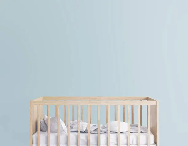 Interior design for nursery bedroom with wooden crib. Scandinavian style on empty green wall. Stock photo