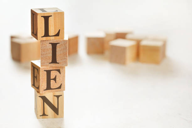 istock Four wooden cubes arranged in stack with word LIEN on them, space for text / image at down right corner 1227171635