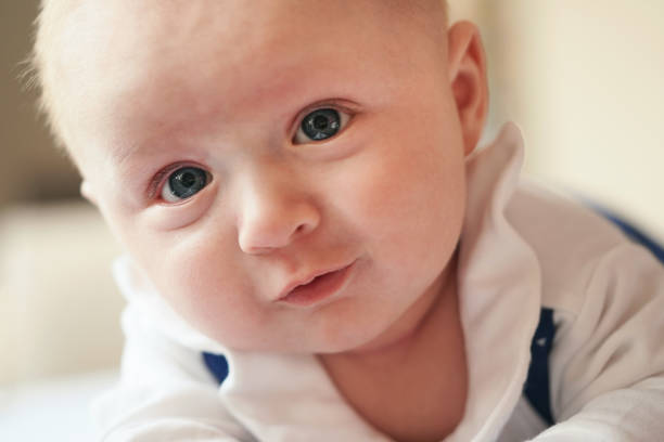 istock Four months old baby boy crawling on bed, detail on his head and face expression 1227171644