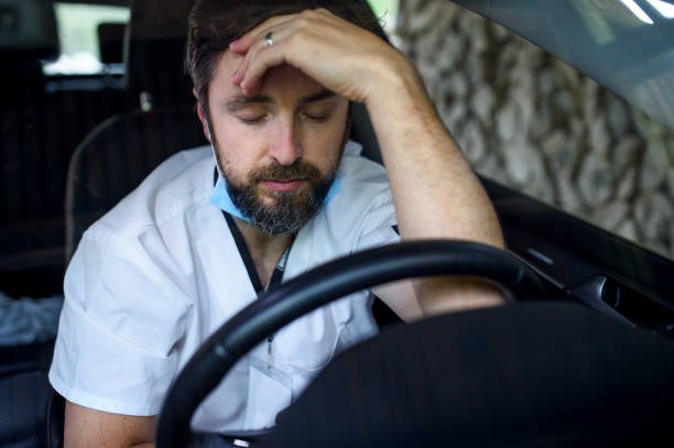 istock Tired and exhausted doctor sitting in car after long and difficult shift. 1227173737