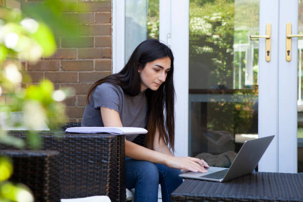 istock University student studying in garden 1227174154
