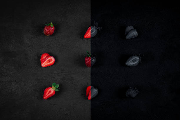 Strawberry on dark background. Top view. Copy space for text message. Colorful, black and white.  Creative concept.