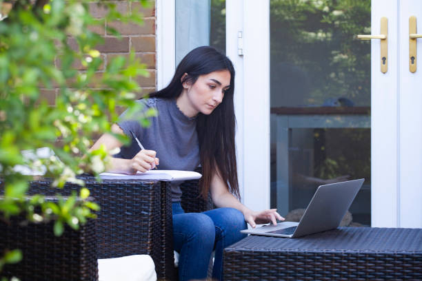 istock University student studying in garden 1227175351
