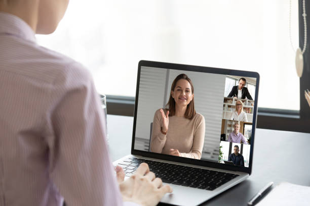 istock Female worker talk on video call with coworkers 1227175376