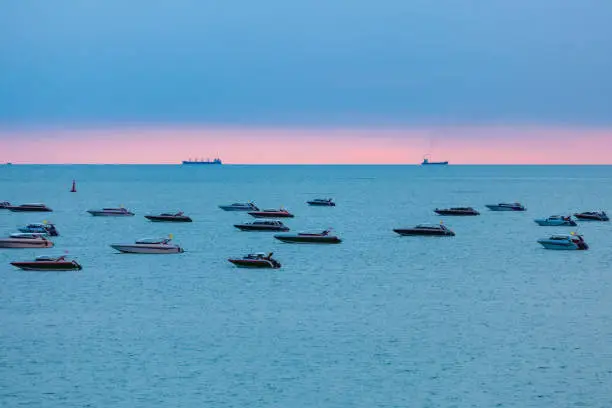 Photo of After sundown it's time to memorable of clam sea and wonderful combination blue and pink color sky, The speedboat float in pattaya beach