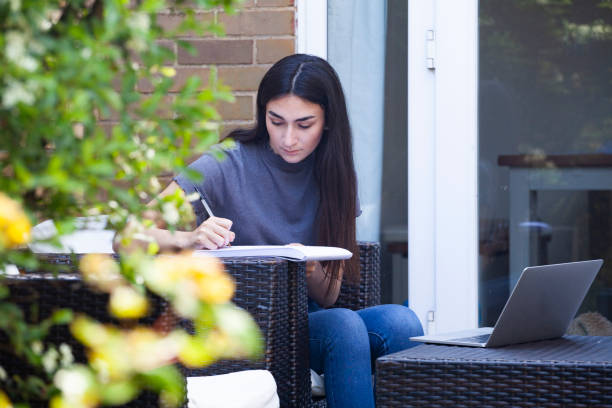 istock University student studying in garden 1227175644