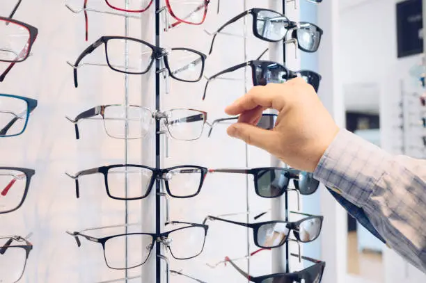 Choosing glasses in a eyewear store