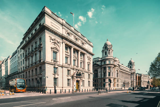 London, UK - 3rd May 2011: Warm dawn sunlight illuminated the iconic Portland stone facade, windows, balcony and ornate entrance gates of Buckingham Palace, London residence of the British Monarch, from the Victoria Memorial on The Mall. Composite panoramic image created from eleven contemporaneous sequential photographs.