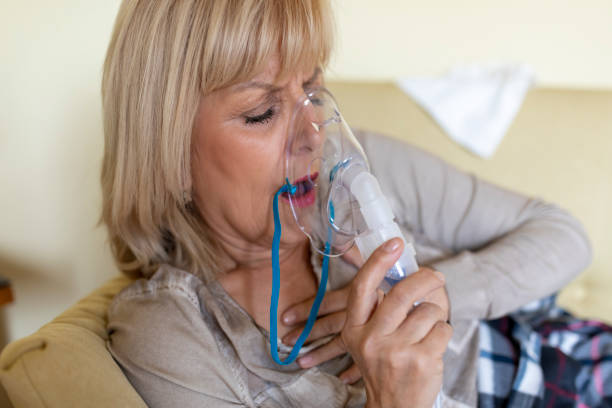 istock Sick Older Woman in the Bed with Asthmatic Problems. 1227177085