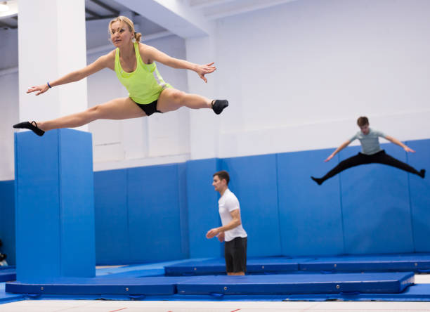 istock Woman jumping in trampoline center 1227178195