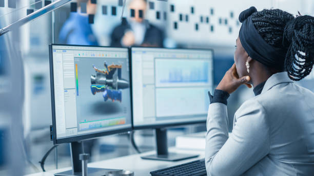 istock Beautiful Female Engineer Working on Personal Computer in the High-Tech Industrial Factory, She Uses CAD Software Designing 3D Turbine. Over the Shoulder Shot. 1227179730