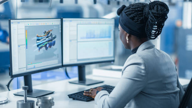 istock Beautiful Female Engineer Working on Personal Computer in the High-Tech Industrial Factory, She Uses CAD Software Designing 3D Turbine. Over the Shoulder Shot. 1227179796