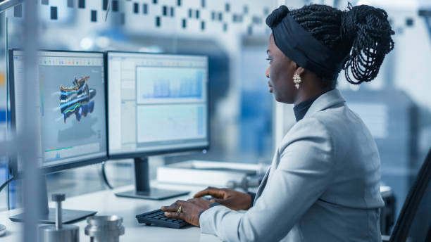 istock Beautiful Female Engineer Working on Personal Computer in the High-Tech Industrial Factory, She Uses CAD Software Designing 3D Turbine. Modern High-Tech Industrial Factory Office. 1227179853