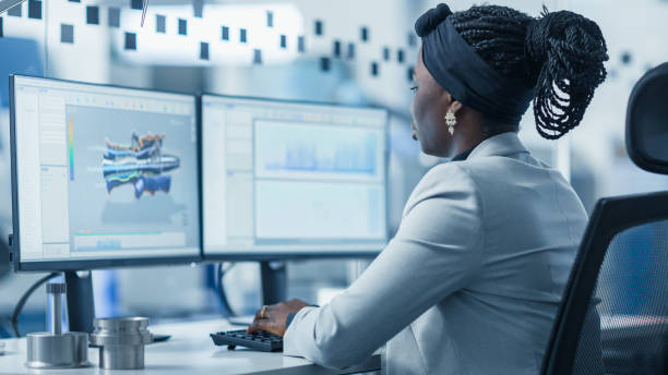 istock Beautiful Female Engineer Working on Personal Computer in the High-Tech Industrial Factory, She Uses CAD Software Designing 3D Turbine. Modern High-Tech Industrial Factory Office. 1227179909
