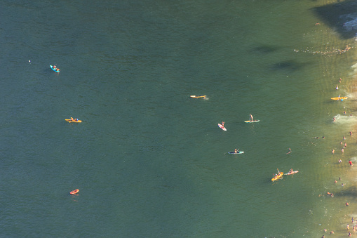 people practicing Stand up Paddle on the red beach seen from the top of Morro da Urca in Rio de Janeiro
