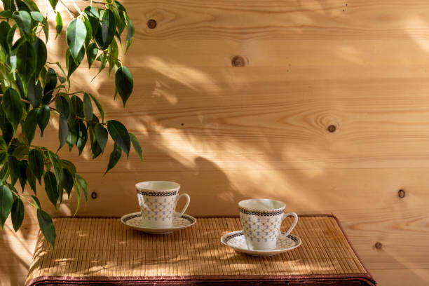 istock Two empty cups for coffee on the table in the patio lit by morning sun. 1227180136